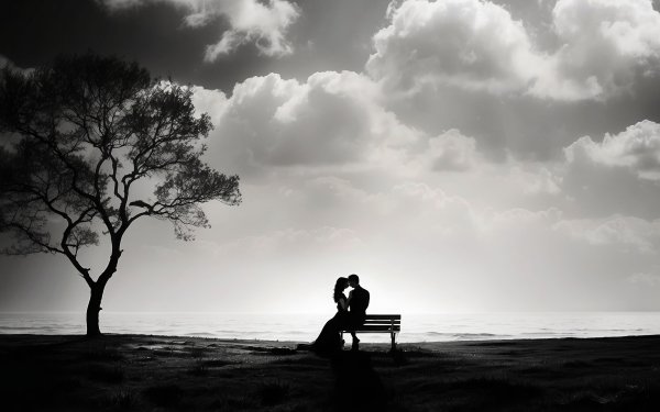 Romantic silhouette of a couple embracing on a bench under a tree, with dramatic clouds in the background, perfect for a HD desktop wallpaper.