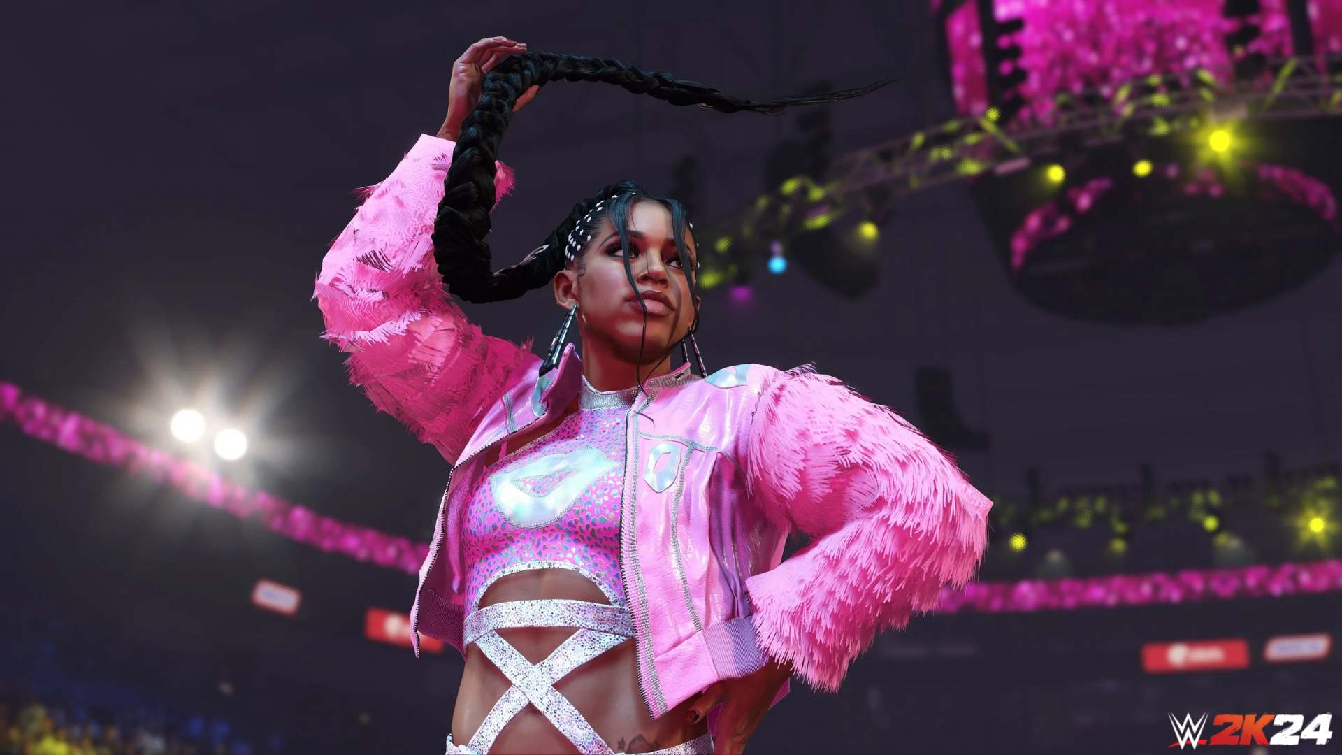 HD desktop wallpaper featuring a WWE 2K24 video game female wrestler in a victory pose with a pink jacket in an arena setting.