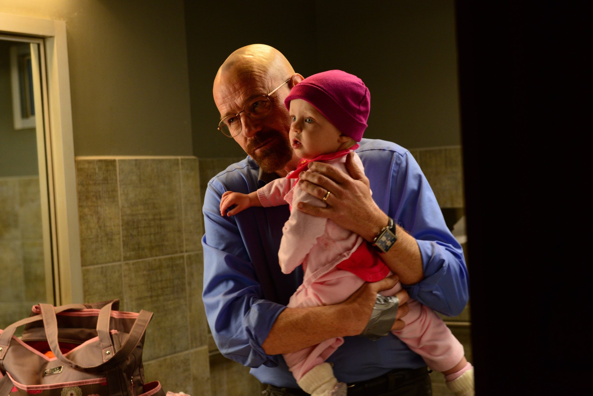 HD wallpaper featuring a scene from the TV show Breaking Bad, with the character Walter White holding a baby.