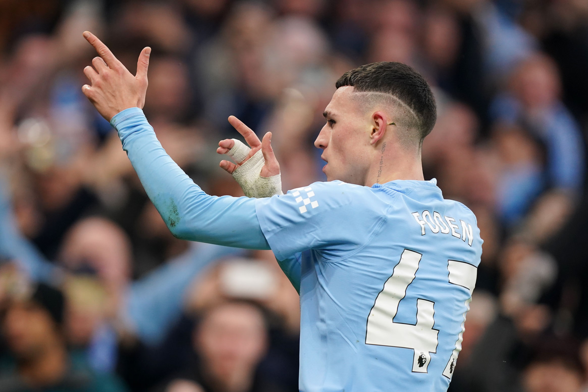 Manchester City F.C. soccer player celebrating on the pitch, wearing number 47 jersey, in a high-definition desktop wallpaper.