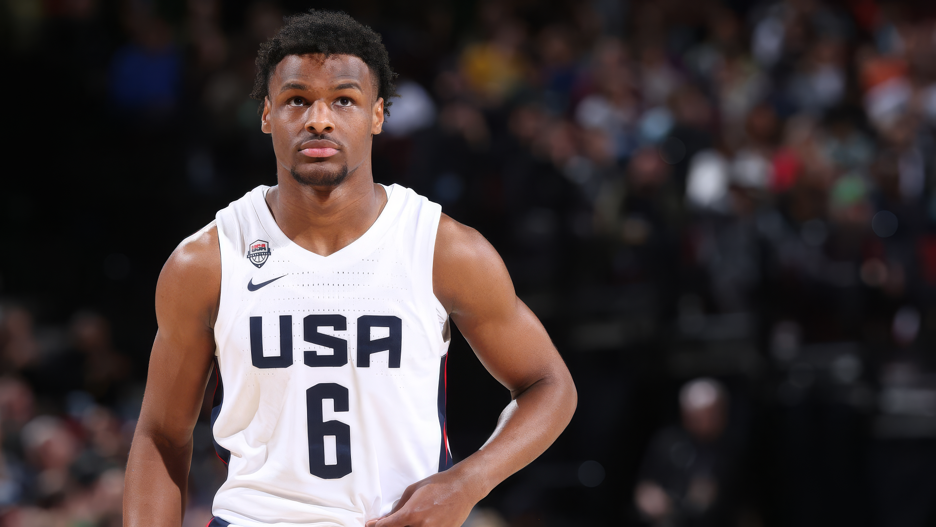 HD desktop wallpaper of a basketball player in a USA jersey on the court, representing the sport's intensity and focus for fans.