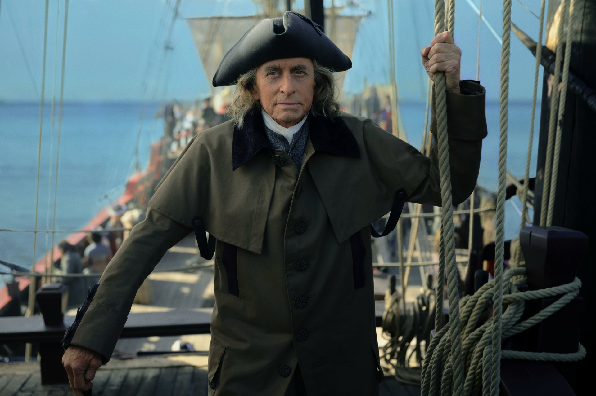 HD desktop wallpaper featuring a character from the TV show Franklin, dressed in period costume on the deck of a ship.