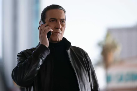 HD wallpaper from the movie The Family Plan featuring a focused man talking on a phone.