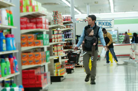 HD desktop wallpaper from The Family Plan featuring a scene with a man and child in a grocery store aisle.