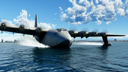 Microsoft Flight Simulator HD wallpaper featuring a realistic sea plane touching down on water under a blue sky with puffy clouds.