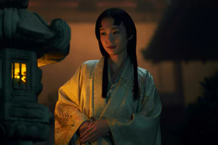 HD wallpaper featuring a scene from the 2024 TV show Shogun, with a serene woman in traditional attire by a lit lantern.