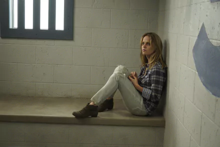A dramatic scene from the TV show *The Rookie*, featuring a character sitting on a bench in a stark room, conveying a sense of tension and contemplation. High-definition wallpaper.