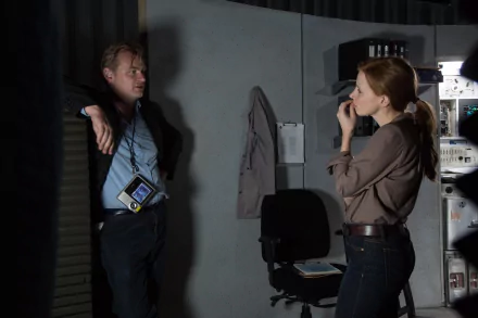 Two individuals in a tense discussion in a dimly-lit room, suitable as a HD desktop wallpaper or background.