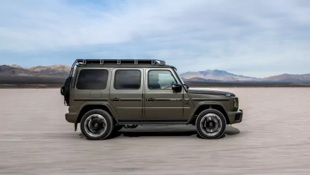 A sleek Mercedes-AMG G63 SUV in an olive green finish, showcased against a barren landscape and blue sky, serves as an eye-catching high-definition desktop wallpaper.