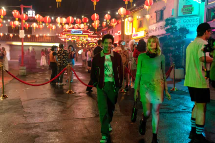 HD wallpaper with a vibrant night scene from the movie The Greatest Hits featuring actors in character walking through a lively street adorned with Chinese lanterns.