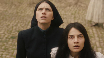 Two actresses portraying characters with worried expressions from the movie 'The First Omen' in an HD desktop wallpaper.