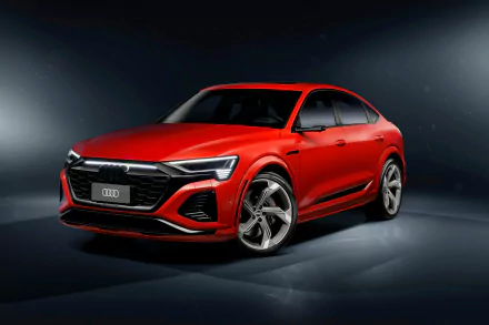 Red Audi SQ8 luxury SUV positioned prominently against a dark studio background, showcasing its design for use as a high-definition desktop wallpaper.