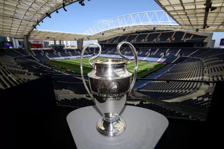 UEFA Champions League trophy displayed in a stadium setting, available as HD desktop wallpaper and background.