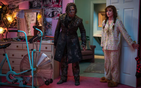 HD desktop wallpaper with a scene from Lisa Frankenstein, featuring two characters standing in a vibrantly colored room.