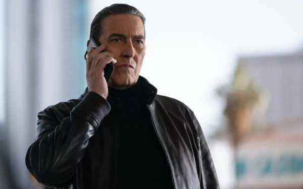 HD wallpaper from the movie The Family Plan featuring a focused man talking on a phone.