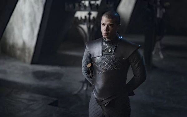 HD wallpaper of a Game of Thrones character dressed in armor standing solemnly in a dimly lit medieval setting.
