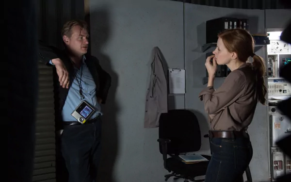 Two individuals in a tense discussion in a dimly-lit room, suitable as a HD desktop wallpaper or background.
