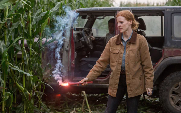 HD Wallpaper of a scene from the movie Interstellar featuring the character next to a vehicle with a flare, amidst cornfields.
