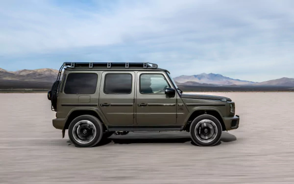 A sleek Mercedes-AMG G63 SUV in an olive green finish, showcased against a barren landscape and blue sky, serves as an eye-catching high-definition desktop wallpaper.