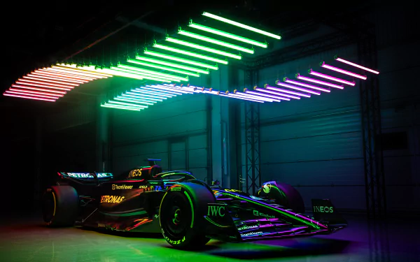 HD wallpaper of a Mercedes-AMG F1 W14 race car under vibrant neon lights.
