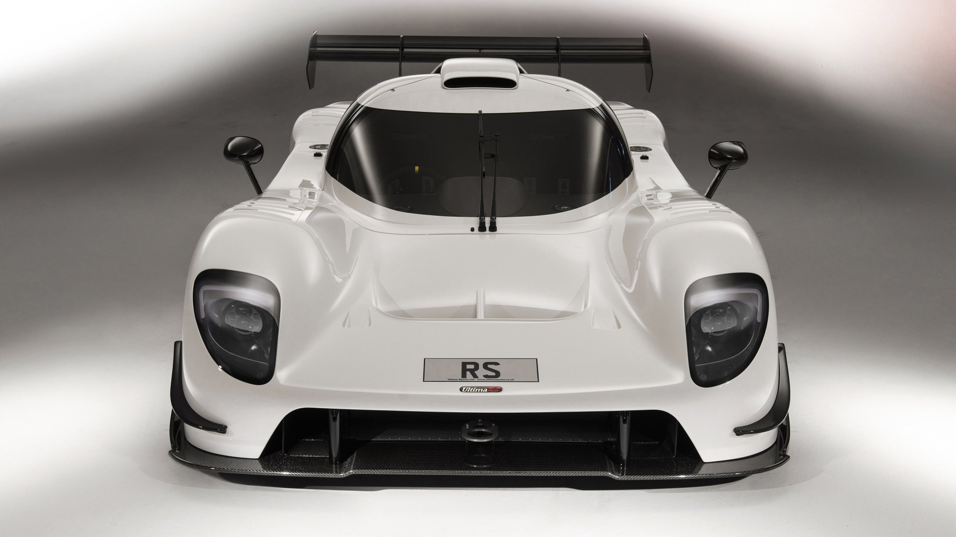 HD desktop wallpaper featuring a frontal view of a white Ultima RS sports car, showcasing its dynamic design and aerodynamic features.