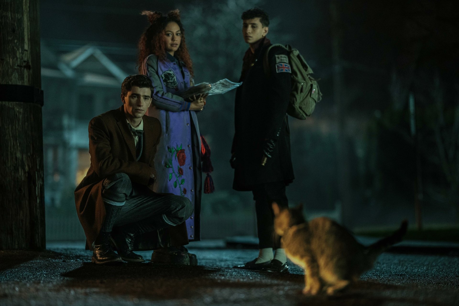 HD desktop wallpaper featuring characters from the TV show Dead Boy Detectives in a moody, nighttime setting, with a cat in the foreground.