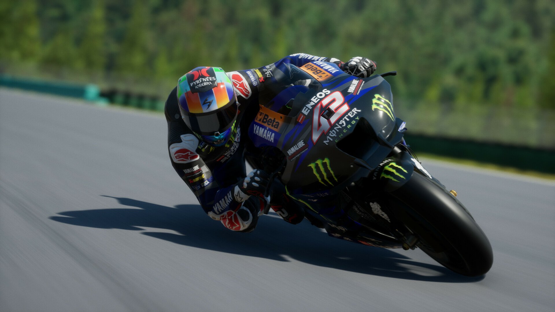 HD desktop wallpaper from the video game MotoGP 24, featuring a motorcycle racer leaning sharply into a turn on a race track.
