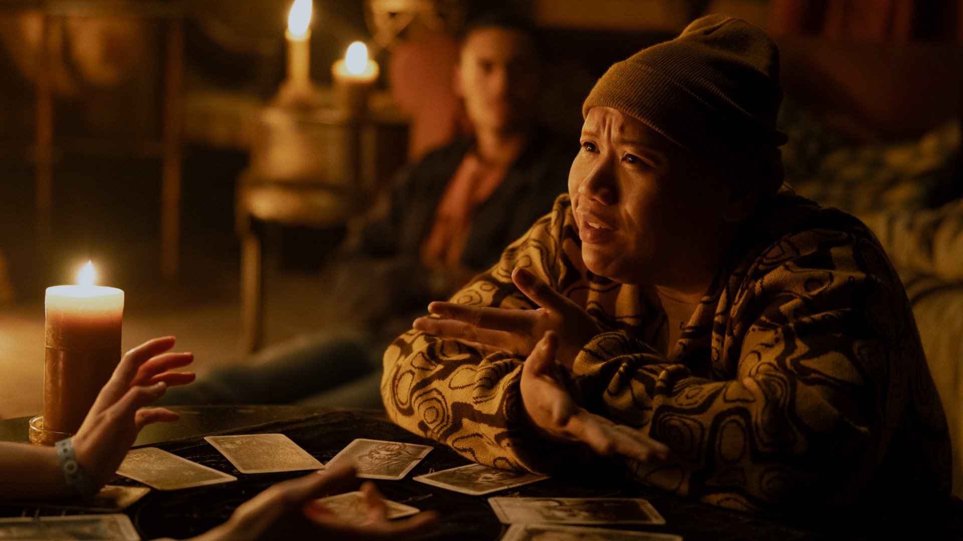 HD desktop wallpaper from the movie Tarot (2024) featuring Jacob Batalon engaged in a candlelit tarot card reading.