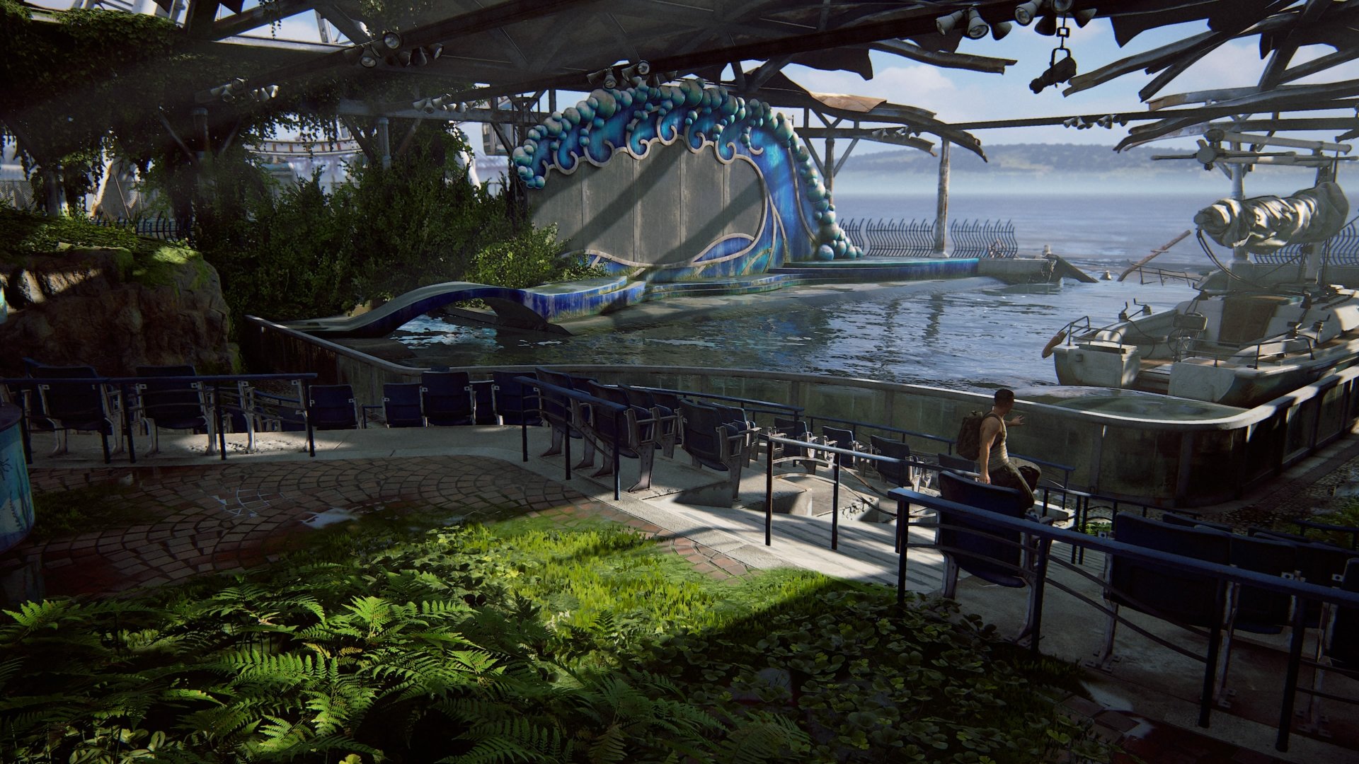 4K Ultra HD desktop wallpaper featuring a serene, overgrown aquatic scene from The Last of Us Part II with a character sitting near a pool and a large serpent-like statue.