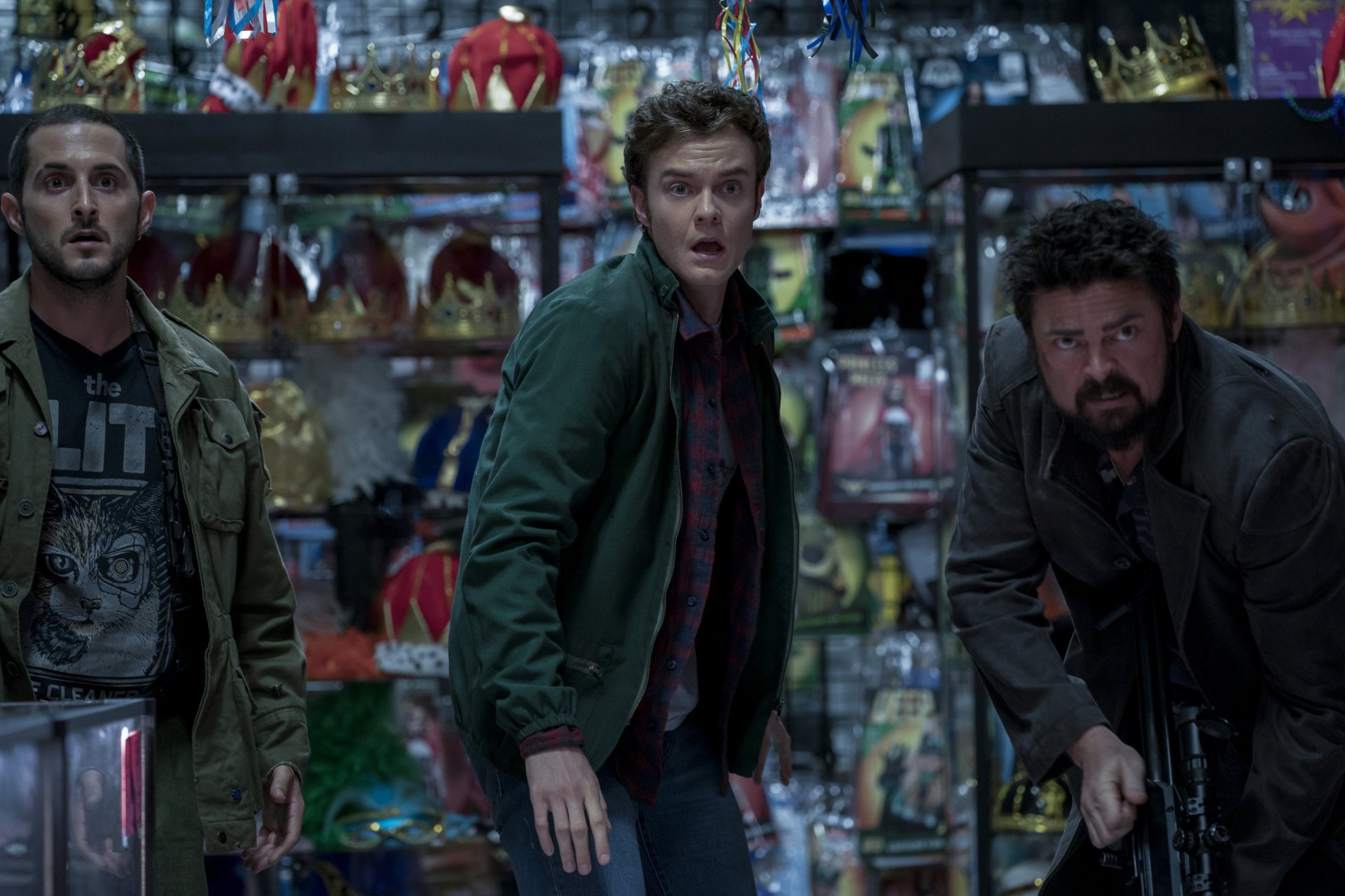 HD desktop wallpaper featuring a dramatic scene from the TV Show The Boys (2019), with three characters standing in a tense moment inside a colorful store filled with various toys and costumes.