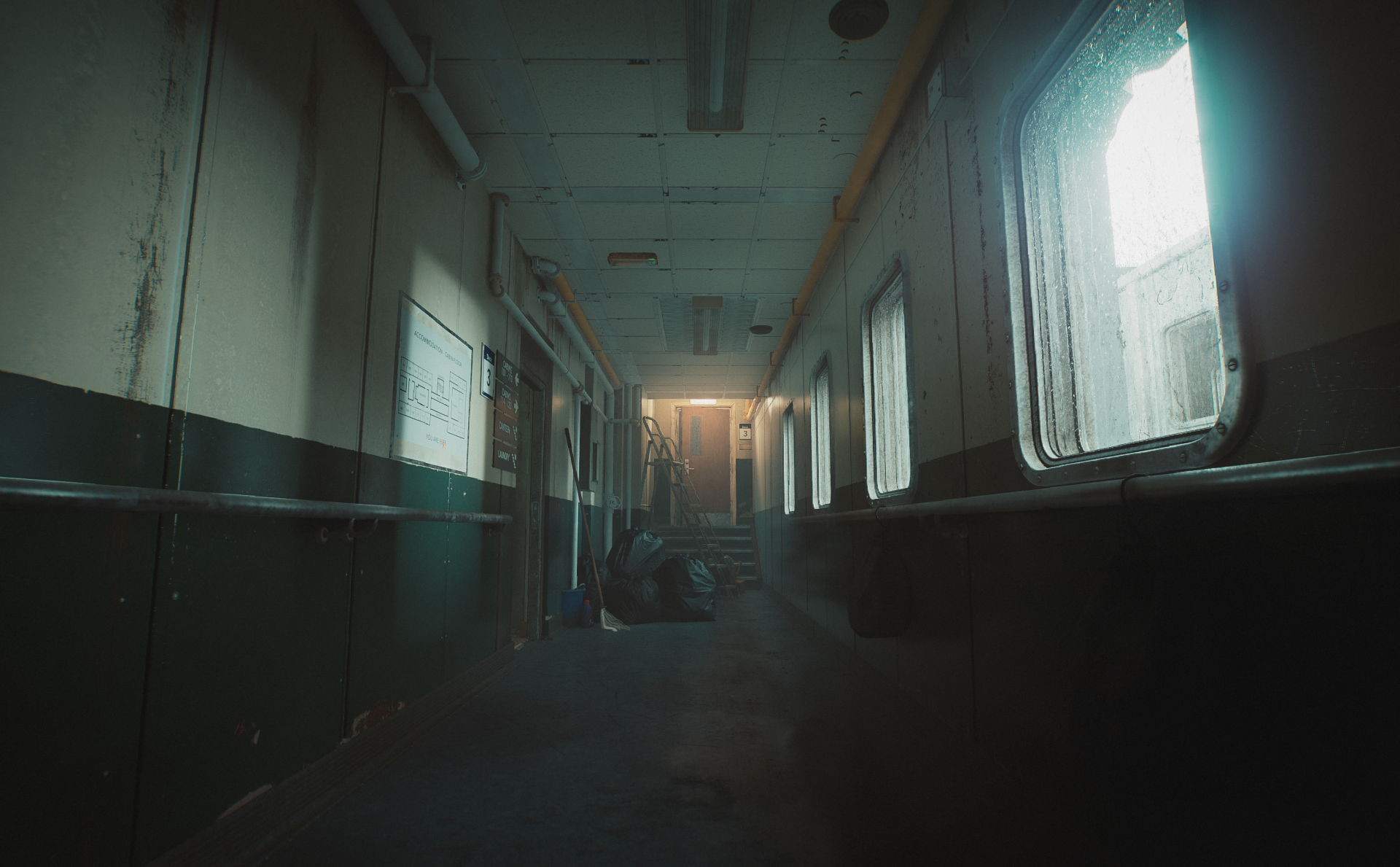 An HD desktop wallpaper and background featuring a dimly lit corridor from the video game Still Wakes the Deep, showcasing eerie lighting and atmospheric design.