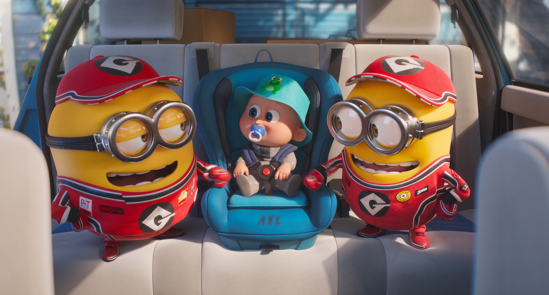 HD desktop wallpaper featuring two Minions in red outfits and a baby in a car seat from the movie Despicable Me 4.