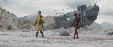 HD wallpaper featuring Wolverine and Deadpool standing in a rocky terrain with a wrecked ship in the background, from the movie Deadpool & Wolverine.