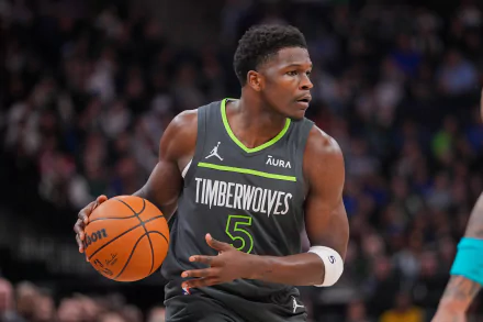HD wallpaper featuring Anthony Edwards of the Minnesota Timberwolves in action on the basketball court, dressed in his vibrant team uniform.