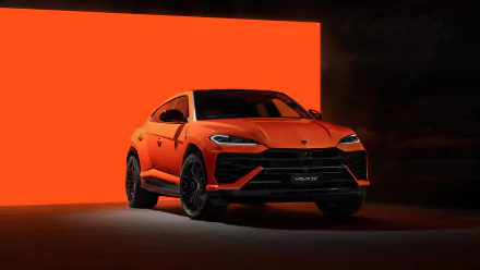 HD wallpaper image of an orange Lamborghini Urus positioned against a vivid orange backdrop, highlighting the dynamic design and elegance of the vehicle.