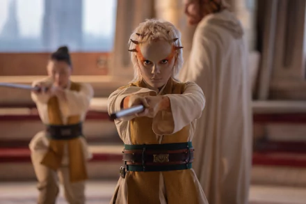 Scene from The Acolyte (2024) TV show featuring characters in warrior attire, focused and holding swords, set against a dramatic, well-lit backdrop. HD desktop wallpaper and background.