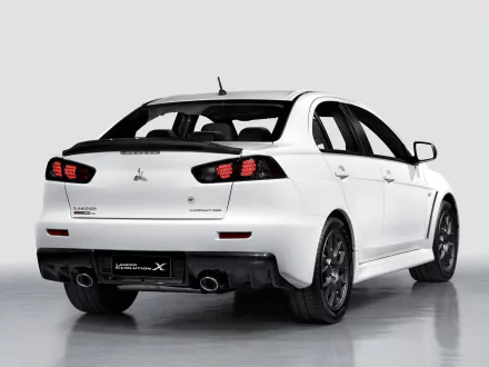 HD desktop wallpaper featuring a white Mitsubishi Lancer Evolution X from a rear three-quarter angle. The car's sporty design and bold rear lights are prominently displayed against a clean, neutral background.