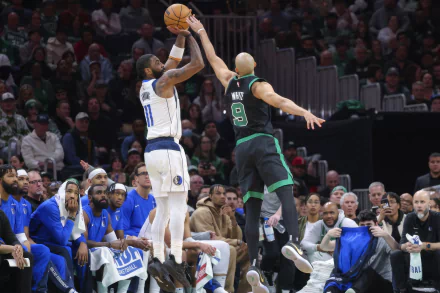 HD desktop wallpaper featuring an intense NBA basketball game between the Dallas Mavericks and the Boston Celtics, with Kyrie Irving taking a shot. Players, coaches, and fans are visible in the background.