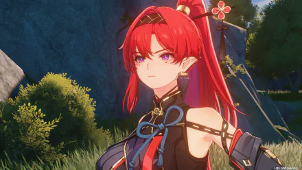 HD desktop wallpaper featuring Yinlin from the video game Wuthering Waves, set against a lush, nature background. Yinlin, with vibrant red hair and intricate attire, gazes intensely into the distance.