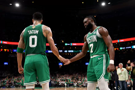 Boston Celtics players, Jayson Tatum and Jaylen Brown, share a moment on the basketball court in this HD desktop wallpaper. Both are in green uniforms with their names and numbers visible.