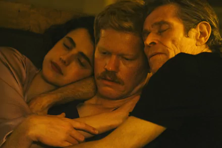 A warm and intimate scene from the movie Kinds of Kindness, featuring three characters in a close embrace, showcasing their connection and affection in this HD desktop wallpaper.