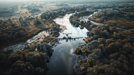 A-10C attack jet flying low over a winding river and wooded terrain — 2K Quad HD PC desktop wallpaper and background.