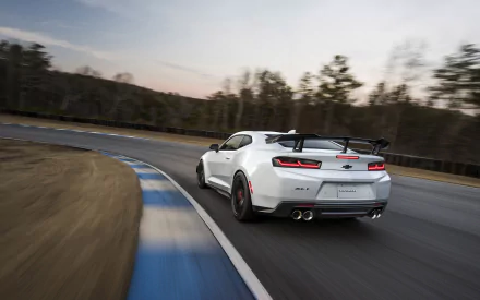 HD desktop wallpaper featuring a Chevrolet Camaro ZL1 1LE racing around a track, showcasing its speed and power against a blurred background.