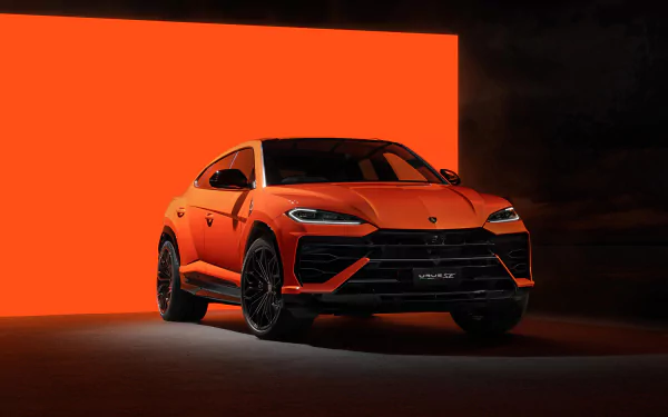 HD wallpaper image of an orange Lamborghini Urus positioned against a vivid orange backdrop, highlighting the dynamic design and elegance of the vehicle.