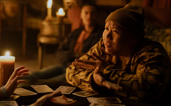 HD desktop wallpaper from the movie Tarot (2024) featuring Jacob Batalon engaged in a candlelit tarot card reading.