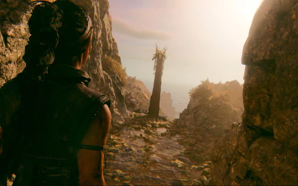 HD desktop wallpaper and background featuring a scene from the video game Senua's Saga: Hellblade II. A character gazes down a rugged path towards a misty horizon with rocky cliffs on either side.