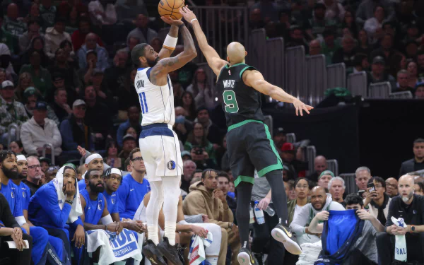 HD desktop wallpaper featuring an intense NBA basketball game between the Dallas Mavericks and the Boston Celtics, with Kyrie Irving taking a shot. Players, coaches, and fans are visible in the background.