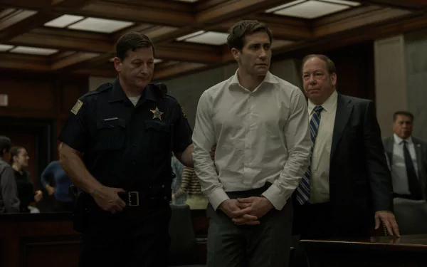 HD wallpaper from the TV show Presumed Innocent (2024), featuring Jake Gyllenhaal in a courtroom setting, flanked by a police officer and a man in a suit.