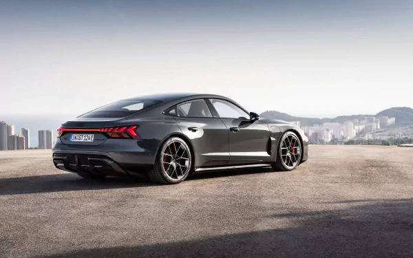 HD desktop wallpaper featuring the sleek and modern Audi RS e-Tron GT against an urban backdrop. The car's design embodies luxury and high performance.