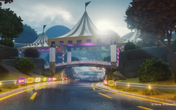 HD desktop wallpaper featuring a vibrant race track from the video game Disney Speedstorm, showcasing a scenic road with a circus tent bridge and lush greenery.